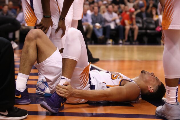 PHOENIX, ARIZONA - APRIL 03:  Devin Booker #1 of the Phoenix Suns holds his ankle after an injury during the first half of the NBA game against the Utah Jazz at Talking Stick Resort Arena on April 03, 2019 in Phoenix, Arizona. (Photo by Christian Petersen/Getty Images)