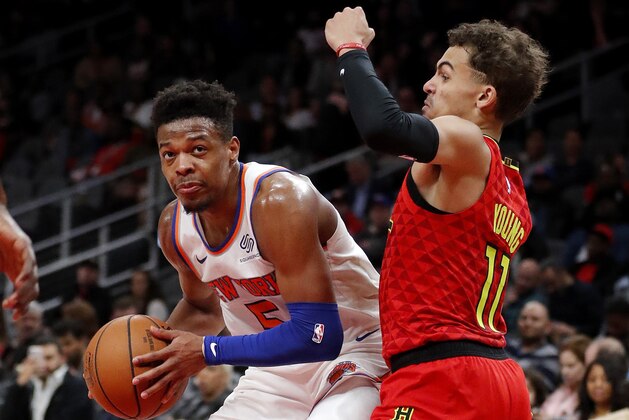 New York Knicks guard Dennis Smith Jr. (5) works against Atlanta Hawks guard Trae Young (11) during the second half of an NBA basketball game Thursday, Feb. 14, 2019, in Atlanta. New York won 106-91. (AP Photo/John Bazemore)