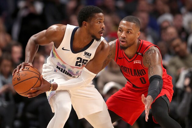 DENVER, COLORADO - JANUARY 13:  Malik Beasley #25 of the Denver Nuggets is guarded by Damian Lillard #0 of the Portland Trail Blazers at  the Pepsi Center on January 13, 2019 in Denver, Colorado. NOTE TO USER: User expressly acknowledges and agrees that, by downloading and or using this photograph, User is consenting to the terms and conditions of the Getty Images License Agreement. (Photo by Matthew Stockman/Getty Images)