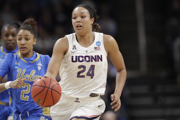 Connecticut forward Napheesa Collier (24) drives down court with UCLA guard Ahlana Smith (2) in pursuit during the first half of a regional semifinal game against UCLA in the NCAA women's college basketball tournament, Friday, March 29, 2018, in Albany, N.Y. (AP Photo/Kathy Willens)