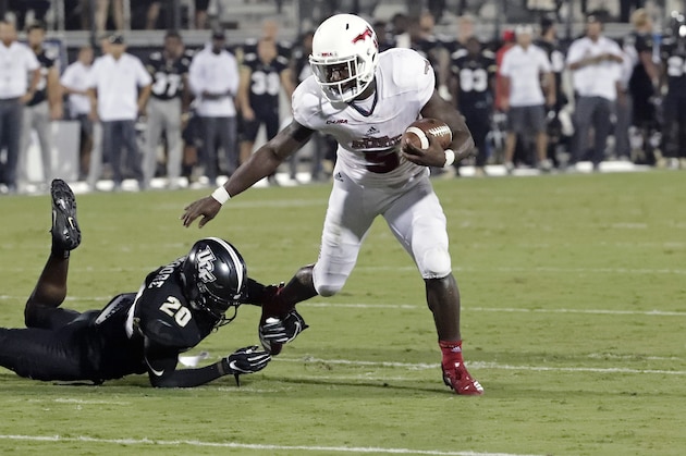 Florida Atlantic running back Devin Singletary (5) slips past Central Florida defensive back Brandon Moore (20) for a 9-yard touchdown run during the first half of an NCAA college football game, Friday, Sept. 21, 2018, in Orlando, Fla. (AP Photo/John Raoux)