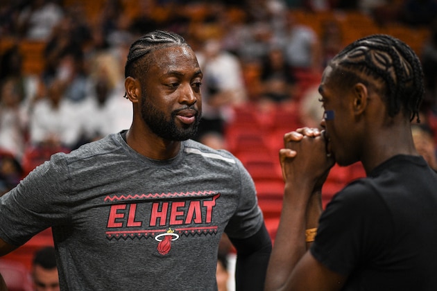 MIAMI, FL - MARCH 02: Dwyane Wade #3 of the Miami Heat speaks to his son Zaire Blessing Dwyane Wade before the game against the Brooklyn Nets in the  half at American Airlines Arena on March 2, 2019 in Miami, Florida. NOTE TO USER: User expressly acknowledges and agrees that, by downloading and or using this photograph, User is consenting to the terms and conditions of the Getty Images License Agreement. (Photo by Mark Brown/Getty Images)