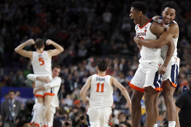 Virginia players celebrate after defeating Auburn 63-62 in the semifinals of the Final Four NCAA college basketball tournament, Saturday, April 6, 2019, in Minneapolis. (AP Photo/Charlie Neibergall)