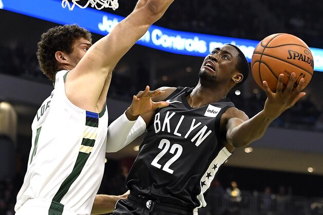 MILWAUKEE, WISCONSIN - APRIL 06:  Caris LeVert #22 of the Brooklyn Nets shoots a lay up against Brook Lopez #11 of the Milwaukee Bucks in the first half at Fiserv Forum on April 06, 2019 in Milwaukee, Wisconsin.  NOTE TO USER: User expressly acknowledges and agrees that, by downloading and or using this photograph, User is consenting to the terms and conditions of the Getty Images License Agreement.  (Photo by Quinn Harris/Getty Images)
