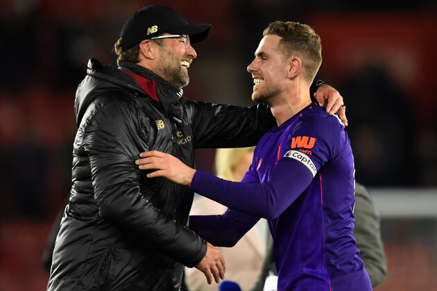 Liverpool's German manager Jurgen Klopp celebrates with Liverpool's English midfielder Jordan Henderson (R) on the pitch after the English Premier League football match between Southampton and Liverpool at St Mary's Stadium in Southampton, southern England on April 5, 2019. - Liverpool won the game 3-1. (Photo by Glyn KIRK / AFP) / RESTRICTED TO EDITORIAL USE. No use with unauthorized audio, video, data, fixture lists, club/league logos or 'live' services. Online in-match use limited to 120 images. An additional 40 images may be used in extra time. No video emulation. Social media in-match use limited to 120 images. An additional 40 images may be used in extra time. No use in betting publications, games or single club/league/player publications. /         (Photo credit should read GLYN KIRK/AFP/Getty Images)