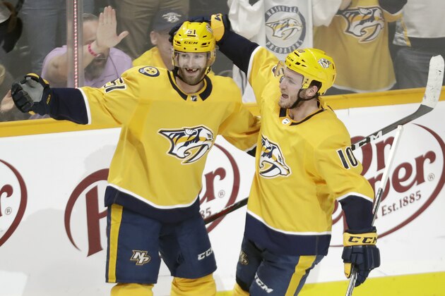 Nashville Predators center Colton Sissons (10) celebrates with Austin Watson (51) after Sissons scored against the Chicago Blackhawks during the third period of an NHL hockey game Saturday, April 6, 2019, in Nashville, Tenn. The Predators won 5-2. The win gave the Predators first place in the Central Division for the Stanley Cup playoffs. (AP Photo/Mark Humphrey)