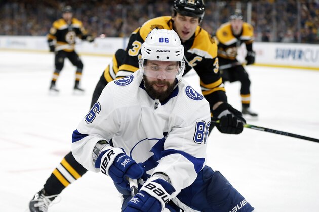 Tampa Bay Lightning's Nikita Kucherov (86) brings the puck into the corner in front of Boston Bruins' Zdeno Chara (33) during the third period of an NHL hockey game in Boston, Saturday, April 6, 2019. (AP Photo/Michael Dwyer)