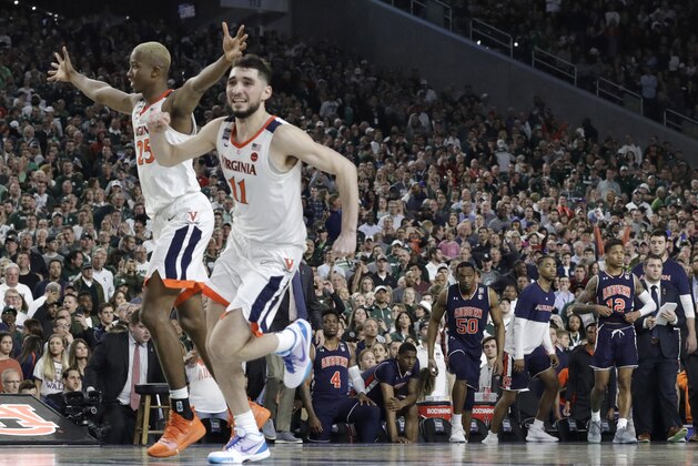 Virginia's Mamadi Diakite, left, and Ty Jerome celebrate at the end of a semifinal round game against Auburn in the Final Four NCAA college basketball tournament, Saturday, April 6, 2019, in Minneapolis. (AP Photo/David J. Phillip)