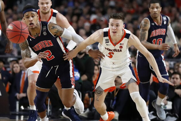 Auburn's Bryce Brown (2) and Virginia's Kyle Guy (5) battle for a loose ball during the second half in the semifinals of the Final Four NCAA college basketball tournament, Saturday, April 6, 2019, in Minneapolis. (AP Photo/Jeff Roberson)