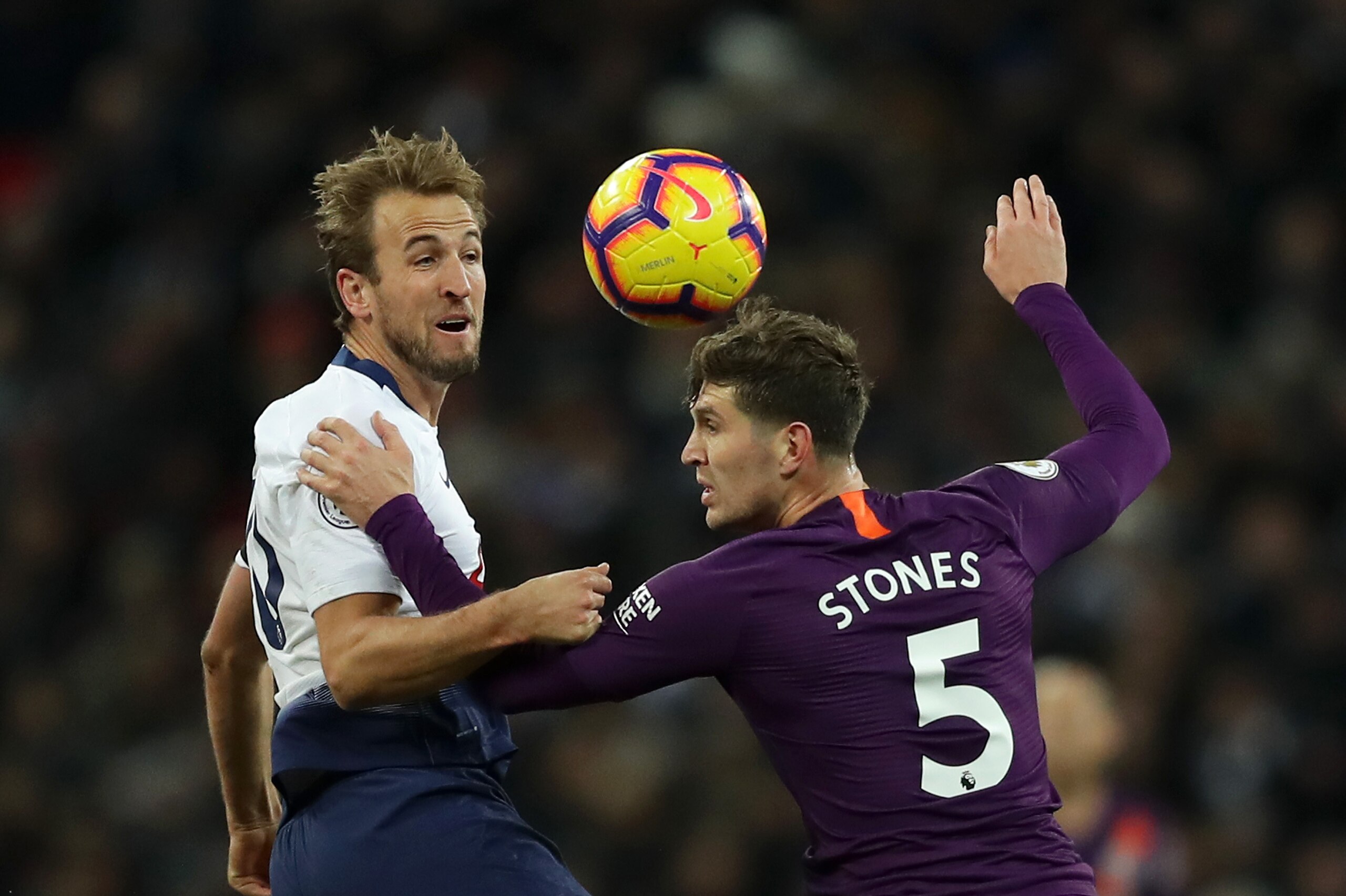 LONDON, ENGLAND - OCTOBER 29:  Harry Kane of Tottenham Hotspur challenges for the ball with John Stones of Manchester City during the Premier League match between Tottenham Hotspur and Manchester City at Wembley Stadium on October 29, 2018 in London, United Kingdom.  (Photo by Richard Heathcote/Getty Images)