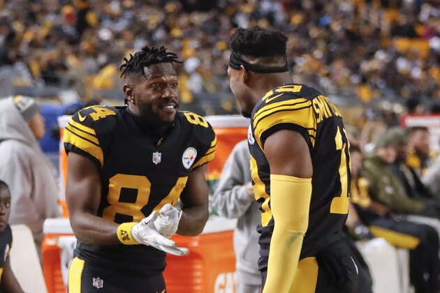 Pittsburgh Steelers wide receiver Antonio Brown (84) taks with wide receiver JuJu Smith-Schuster (19) on the sideline during the second half of an NFL football game against the Carolina Panthers in Pittsburgh, Thursday, Nov. 8, 2018. (AP Photo/Keith Srakocic)