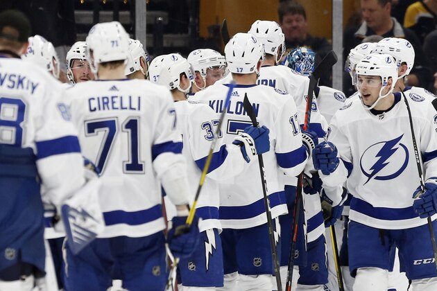 Tampa Bay Lightning's Cameron Gaunce (33) celebrates with teammates after defeating the Boston Bruins in an NHL hockey game in Boston, Saturday, April 6, 2019. (AP Photo/Michael Dwyer)