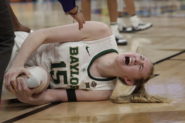 Baylor forward Lauren Cox yells as she holds her left knee, during the second half against Notre Dame in the Final Four championship game of the NCAA women's college basketball tournament Sunday, April 7, 2019, in Tampa, Fla. (AP Photo/John Raoux)