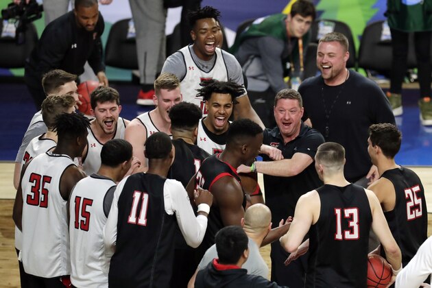 Texas Tech head coach Chris Beard laughs with his players in a huddle during a practice session for the semifinals of the Final Four NCAA college basketball tournament, Friday, April 5, 2019, in Minneapolis. (AP Photo/Matt York)