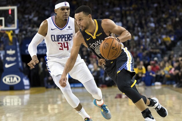 Golden State Warriors guard Stephen Curry (30) dribbles as Los Angeles Clippers forward Tobias Harris (34) defends in the third quarter of an NBA basketball game, Sunday, Dec. 23, 2018, in Oakland, Calif. (AP Photo/John Hefti)
