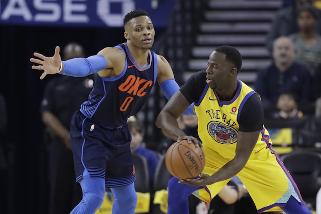 Golden State Warriors' Draymond Green, right, is defended by Oklahoma City Thunder's Russell Westbrook during the first half of an NBA basketball game Saturday, Feb. 24, 2018, in Oakland, Calif. (AP Photo/Marcio Jose Sanchez)