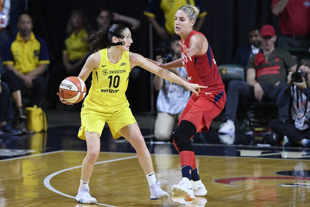 Seattle Storm guard Sue Bird (10) dribbles against Washington Mystics forward Elena Delle Donne, right, during the second half of Game 3 of the WNBA basketball finals, Wednesday, Sept. 12, 2018, in Fairfax, Va. The Storm won 98-82 and the title. (AP Photo/Nick Wass)