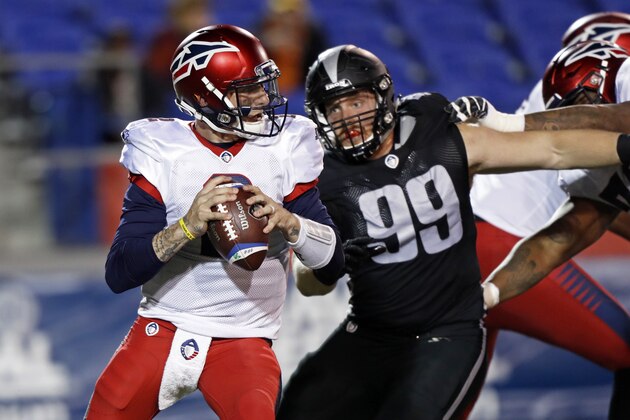 Memphis Express quarterback Johnny Manziel (2) looks for a receiver as he's pressured by Birmingham Iron defensive lineman Jake Payne (99) during a Birmingham Iron at Memphis Express AAF football game, Sunday, March 24, 2019, at Liberty Bowl Memorial Stadium in Memphis, Tenn. against the Memphis won in overtime 31-25. (AP Photo/Wade Payne)