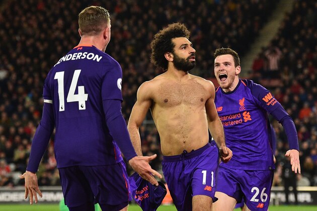 TOPSHOT - Liverpool's Egyptian midfielder Mohamed Salah (C) celebrates with Liverpool's Scottish defender Andrew Robertson (R) and Liverpool's English midfielder Jordan Henderson (L) after scoring their second goal during the English Premier League football match between Southampton and Liverpool at St Mary's Stadium in Southampton, southern England on April 5, 2019. - Liverpool won the game 3-1. (Photo by Glyn KIRK / AFP) / RESTRICTED TO EDITORIAL USE. No use with unauthorized audio, video, data, fixture lists, club/league logos or 'live' services. Online in-match use limited to 120 images. An additional 40 images may be used in extra time. No video emulation. Social media in-match use limited to 120 images. An additional 40 images may be used in extra time. No use in betting publications, games or single club/league/player publications. /         (Photo credit should read GLYN KIRK/AFP/Getty Images)