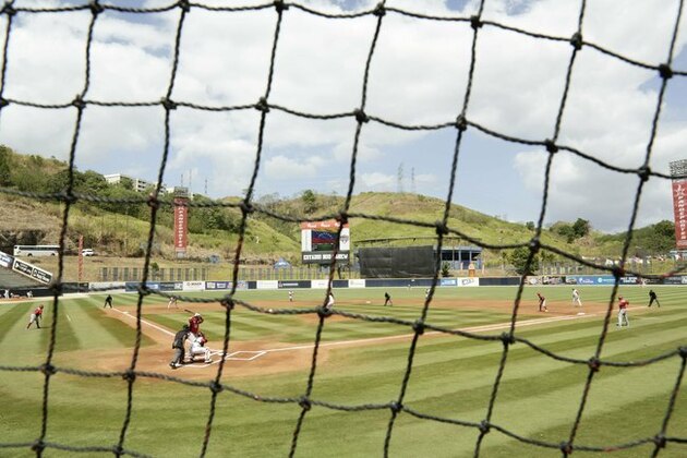 Players of Cuba's Los Leneros de las Tunas and Venezuela's Cardenales de Lara, play a baseball match of the Caribbean Series baseball tournament at Rod Carew stadium in Panama City, Saturday, Feb. 9, 2019. (AP Photo/Arnulfo Franco)