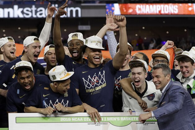 Virginia head coach Tony Bennett celebrates with his team after defeating Texas Tech 85-77 in the overtime in the championship of the Final Four NCAA college basketball tournament, Monday, April 8, 2019, in Minneapolis. (AP Photo/Matt York)