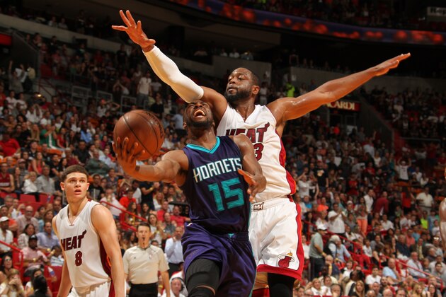 MIAMI, FL - APRIL 7:  Kemba Walker #15 of the Charlotte Hornets goes to the basket against Dwyane Wade #3 of the Miami Heat on April 7, 2015 at American Airlines Arena in Miami, Florida.  NOTE TO USER: User expressly acknowledges and agrees that, by downloading and or using this Photograph, user is consenting to the terms and conditions of the Getty Images License Agreement. Mandatory Copyright Notice: Copyright 2015 NBAE (Photo by Issac Baldizon/NBAE via Getty Images)
