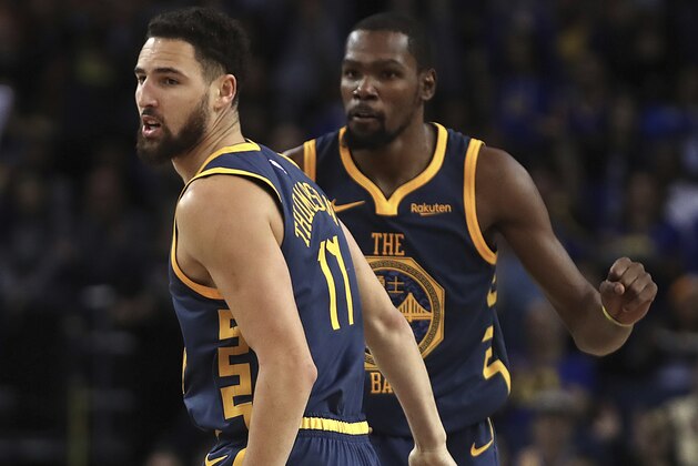 Golden State Warriors' Klay Thompson, left, and Kevin Durant celebrate a score against the Sacramento Kings during the second half of an NBA basketball game Saturday, Nov. 24, 2018, in Oakland, Calif. (AP Photo/Ben Margot)