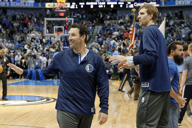 Former Dallas Cowboys quarterback Tony Romo, left, and Dallas Mavericks forward Dirk Nowitzki of Germany, right, warm up on the court before an NBA basketball game against the Denver Nuggets in Dallas, Tuesday, April 11, 2017. (AP Photo/Tony Gutierrez)