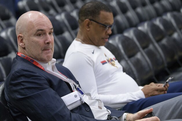 New Orleans Pelicans acting general manager Danny Ferry and head coach Alvin Gentry sit and watch a practice before the first half of an NBA basketball game against the Los Angeles Lakers in New Orleans, La. Saturday, Feb. 23, 2019. (AP Photo/Matthew Hinton)