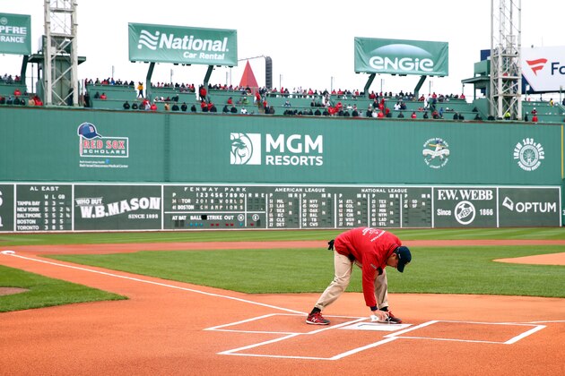 BOSTON, MASSACHUSETTS - APRIL 09:  A grounds crew member works on home plate before the home opener between the Toronto Blue Jays and the Boston Red Sox at Fenway Park on April 09, 2019 in Boston, Massachusetts. (Photo by Maddie Meyer/Getty Images)