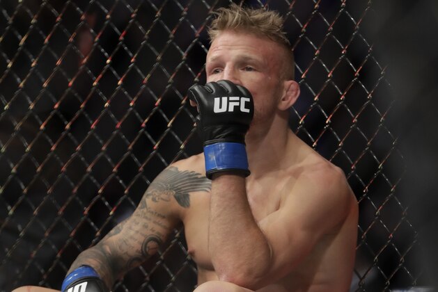 FILE - In this Jan. 20, 2019 file photo, TJ Dillashaw reacts after a flyweight mixed martial arts championship bout against Henry Cejudo at UFC Fight Night in New York.  Dillashaw has surrendered the UFC 135-pound championship because of an “adverse finding” in his last drug test. Dillashaw posted on social media that he would give up the belt after he was informed by the New York State Athletic Commission and the United States Anti-Doping Agency of the results of his test leading up to his last fight in January.  Dillashaw suffered first-round loss to Henry Cejudo and failed to become a two-division champion. (AP Photo/Frank Franklin II, File)