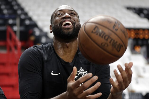 Miami Heat guard Dwyane Wade tosses a basketball before a game against the Philadelphia 76ers, Tuesday, April 9, 2019, in Miami. Wade is playing his final home regular season game before retiring at the end of the season.(AP Photo/Lynne Sladky)