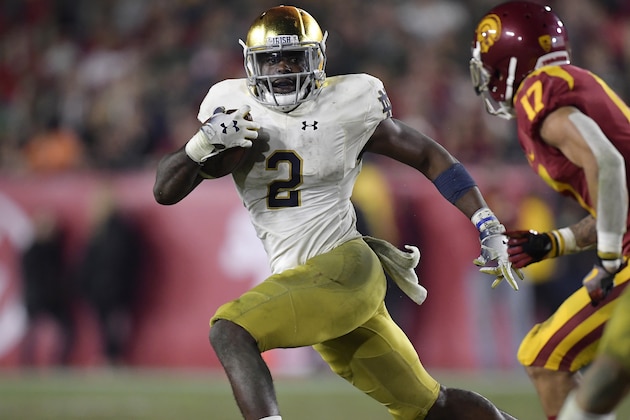 Notre Dame running back Dexter Williams, left, carries the ball as Southern California cornerback Chase Williams defends during the second half of an NCAA college football game Saturday, Nov. 24, 2018, in Los Angeles. Notre Dame won 24-17. (AP Photo/Mark J. Terrill)