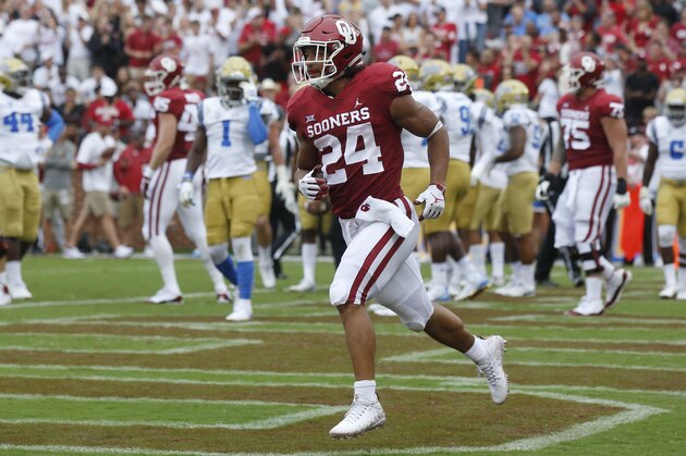 Oklahoma running back Rodney Anderson (24) celebrates after a touchdown in the first quarter of an NCAA college football game against UCLA in Norman, Okla., Saturday, Sept. 8, 2018. (AP Photo/Sue Ogrocki)