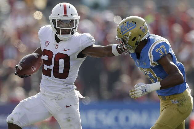 Stanford running back Bryce Love (20) stiff-arms UCLA defensive back Quentin Lake (37) during the first half of an NCAA college football game Saturday, Nov. 24, 2018, in Pasadena, Calif. (AP Photo/Marcio Jose Sanchez)
