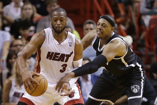 Brooklyn Nets forward Paul Pierce, right, attempts to steal the ball from Miami Heat guard Dwyane Wade (3) during the second half of an NBA basketball game, Wednesday, March 12, 2014 in Miami. The Nets defeated the Heat 96-95. (AP Photo/Wilfredo Lee)