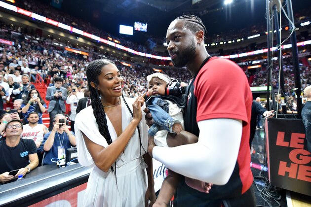 MIAMI, FL - APRIL 9: Actress, Gabrielle Union, and Dwyane Wade #3 of the Miami Heat pose for a photo with their daughter, Kaavia Wade, prior to a game against the Philadelphia 76ers on April 9, 2019 at American Airlines Arena in Miami, Florida. NOTE TO USER: User expressly acknowledges and agrees that, by downloading and or using this Photograph, user is consenting to the terms and conditions of the Getty Images License Agreement. Mandatory Copyright Notice: Copyright 2019 NBAE (Photo by Jesse D. Garrabrant/NBAE via Getty Images)