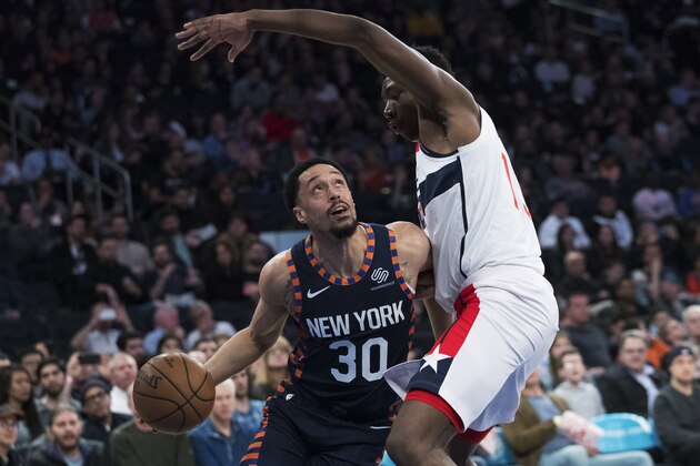 Washington Wizards center Thomas Bryant guards New York Knicks guard John Jenkins (30) during the second half of an NBA basketball game Sunday, April 7, 2019, at Madison Square Garden in New York. The Knicks won 113-110. (AP Photo/Mary Altaffer)