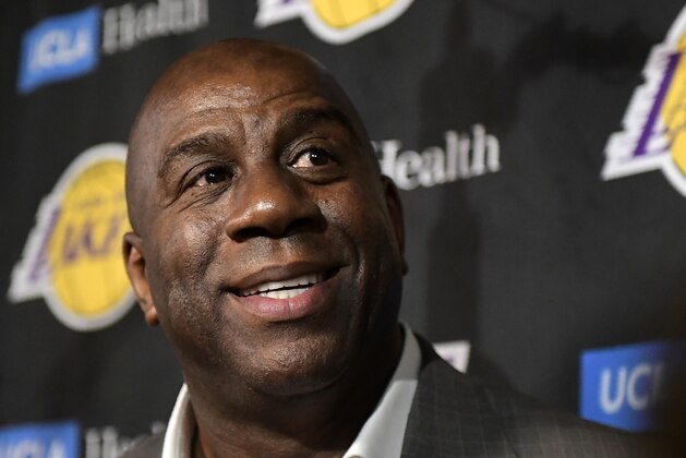 Magic Johnson speaks to reporters prior to an NBA basketball game between the Los Angeles Lakers and the Portland Trail Blazers on Tuesday, April 9, 2019, in Los Angeles. Johnson abruptly quit as the Lakers' president of basketball operations Tuesday night, citing his desire to return to the simpler life he enjoyed as a wealthy businessman and beloved former player before taking charge of the franchise just over two years ago. (AP Photo/Mark J. Terrill)