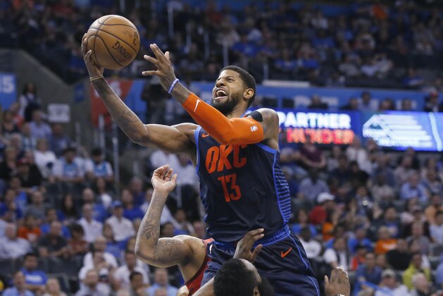 Oklahoma City Thunder forward Paul George (13) collides with Houston Rockets guard James Harden, bottom, and is called for a foul during the second half of an NBA basketball game Tuesday, April 9, 2019, in Oklahoma City. (AP Photo/Sue Ogrocki)