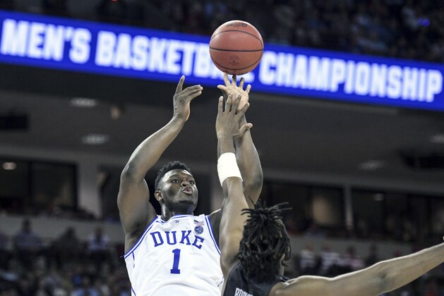 FILE - In this March 24, 2019, file photo, Duke forward Zion Williamson (1) attempts to shoot against Central Florida forward Chad Brown (21) during the first half of a second-round game in the NCAA men's college basketball tournament, in Columbia, S.C. Duke's Zion Williamson and R.J. Barrett are the second freshman teammates to earn first-team All-America honors.  Williamson and Barrett headed The Associated Press All-America team released on Tuesday, April 2, 2019, joined by Tennessee's Grant Williams, Murray State's Ja Morant and Cassius Winston of Michigan State. (AP Photo/Sean Rayford, File)