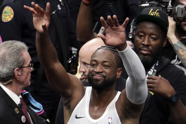 Miami Heat guard Dwyane Wade waves as he walks off the court after playing his final home basketball game, against the Philadelphia 76ers, Tuesday, April 9, 2019, in Miami. Wade is retiring. (AP Photo/Lynne Sladky)
