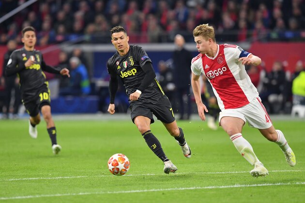 Juventus' Portuguese forward Cristiano Ronaldo (C) vies for the ball with Ajax's Dutch defender Matthijs de Ligt during the UEFA Champions League first leg quarter-final football match between Ajax Amsterdam and Juventus FC at the Johan Cruijff ArenA in Amsterdam on April 10, 2019. (Photo by EMMANUEL DUNAND / AFP)        (Photo credit should read EMMANUEL DUNAND/AFP/Getty Images)
