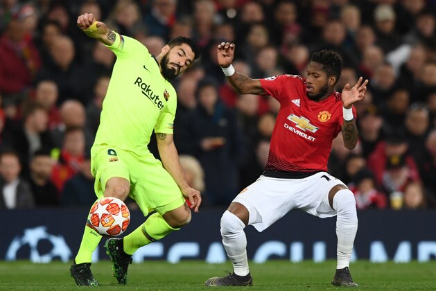 MANCHESTER, ENGLAND - APRIL 10:  Fred of Manchester United and Luis Suarez of Barcelona clash during the UEFA Champions League Quarter Final first leg match between Manchester United and FC Barcelona at Old Trafford on April 10, 2019 in Manchester, England. (Photo by Stu Forster/Getty Images)
