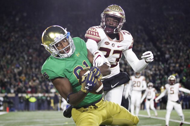 SOUTH BEND, IN - NOVEMBER 10: Miles Boykin #81 of the Notre Dame Fighting Irish makes a three-yard touchdown reception against Hamsah Nasirildeen #23 of the Florida State Seminoles in the first quarter of the game at Notre Dame Stadium on November 10, 2018 in South Bend, Indiana. (Photo by Joe Robbins/Getty Images)