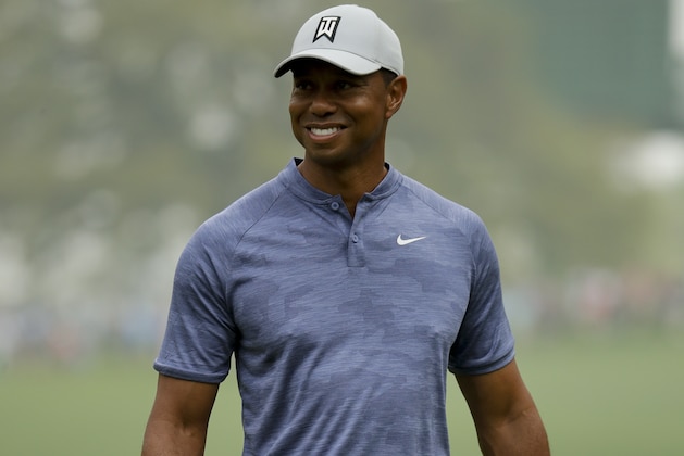 Tiger Woods smiles on the 10th green during a practice round for the Masters golf tournament Monday, April 8, 2019, in Augusta, Ga. (AP Photo/Charlie Riedel)
