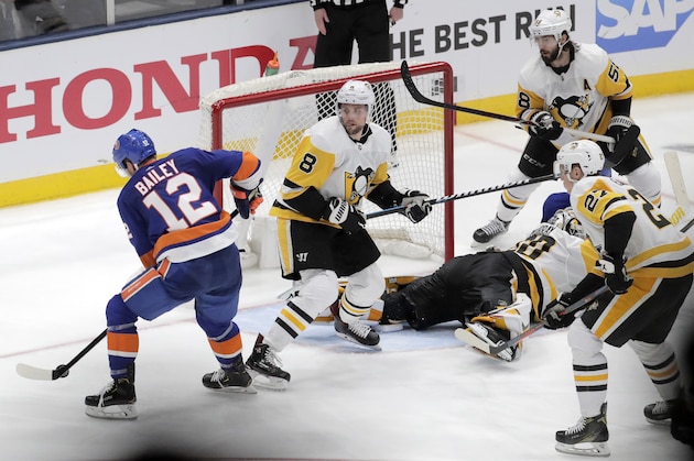 New York Islanders right wing Josh Bailey (12) prepares to take the game-wining shot during overtime of Game 1 of an NHL hockey first-round playoff series against the Pittsburgh Penguins, Wednesday, April 10, 2019, in Uniondale, N.Y. The Islanders won 4-3. (AP Photo/Julio Cortez)