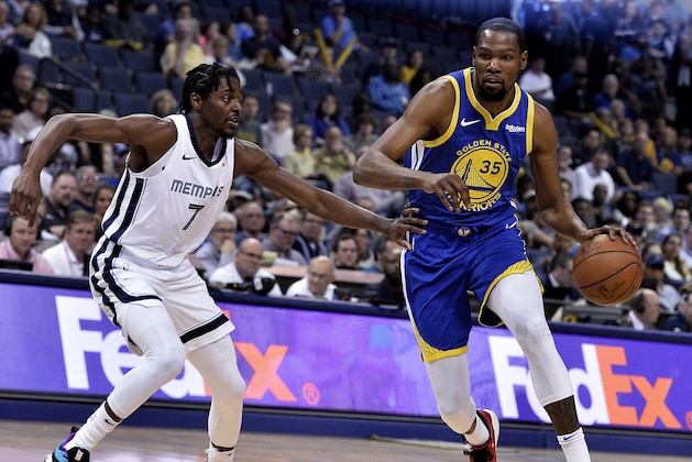 Golden State Warriors forward Kevin Durant (35) handles the ball against Memphis Grizzlies forward Justin Holiday (7) n the first half of an NBA basketball game Wednesday, April 10, 2019, in Memphis, Tenn. (AP Photo/Brandon Dill)