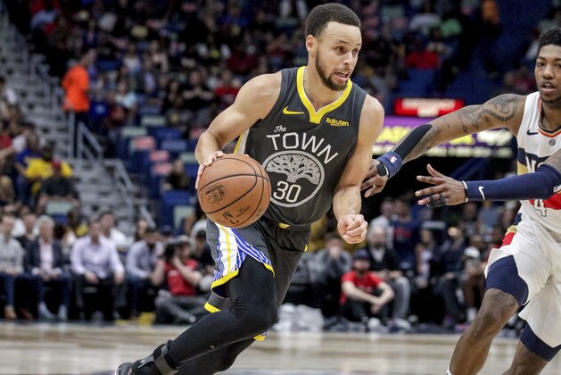 Golden State Warriors guard Stephen Curry (30) drives against New Orleans Pelicans guard Elfrid Payton (4) in the first half of an NBA basketball game in New Orleans, Tuesday, April 9, 2019. (AP Photo/Scott Threlkeld)