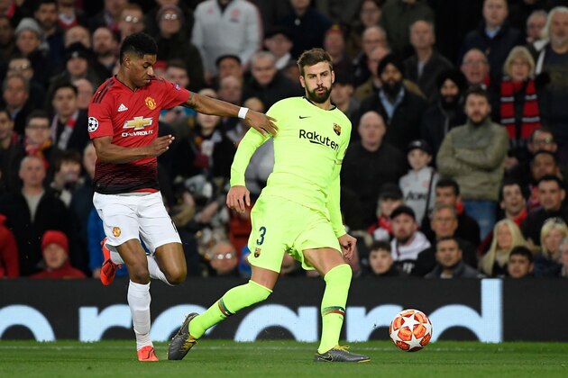 Manchester United's English forward Marcus Rashford (L) vies with Barcelona's Spanish defender Gerard Pique during the UEFA Champions league first leg quarter-final football match between Manchester United and Barcelona at Old Trafford in Manchester, north west England, on April 10, 2019. (Photo by LLUIS GENE / AFP)        (Photo credit should read LLUIS GENE/AFP/Getty Images)